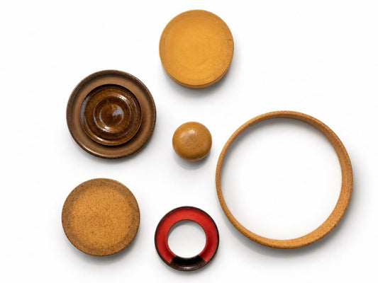 Set of 10 handmade ceramic circles and rings in earth tones, flat lay