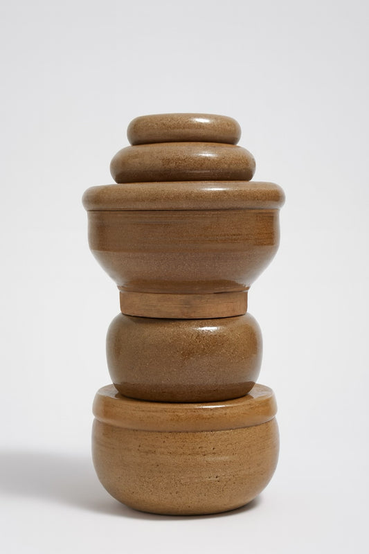 Set of 4 stacked handmade caramel stoneware lidded pots in graduated sizes